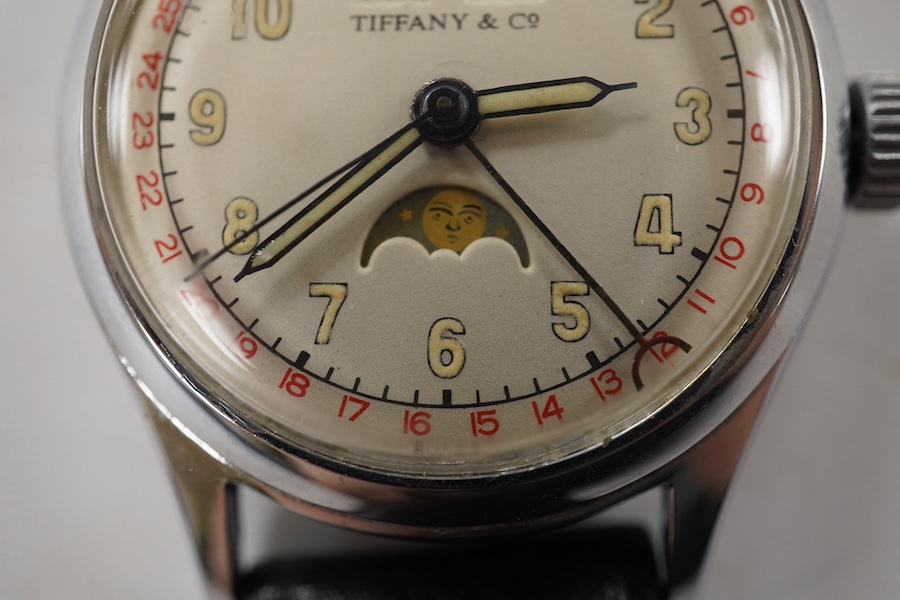 A gentleman's 1940's? steel calandar moonphase manual wind wrist watch, the dial inscribed Tiffany & Co, with Arabic dial and day/date apertures, case diameter 33mm, on a later associated leather strap, movement unsigned